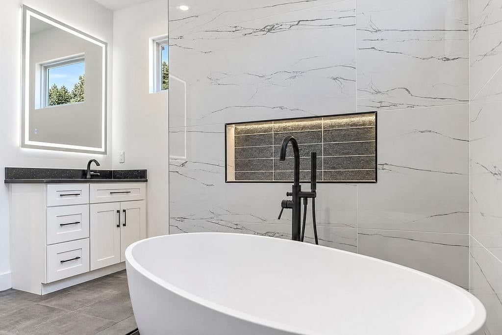 Walk-in shower, freestanding tub and tiled shower at 2738 N 86th Terrace, Kansas City, KS 66109