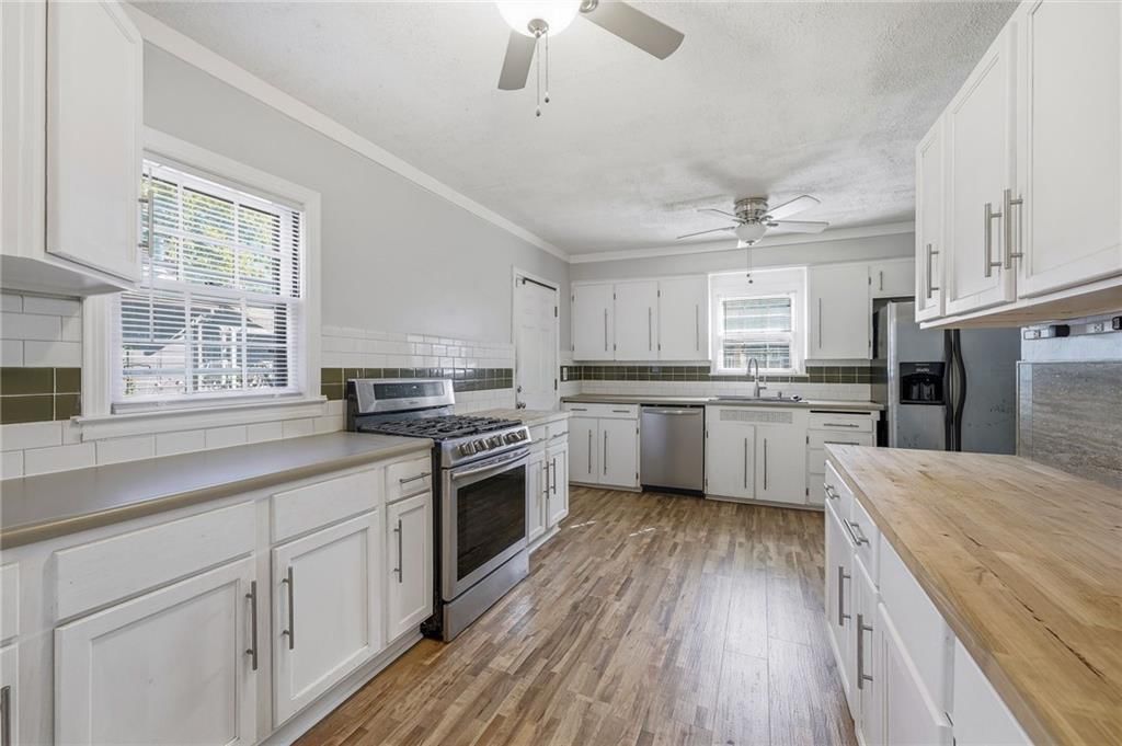 Gas range, butcher block countertops and stainless steel appliances at 9009 E 68th Street, Raytown, MO 64133