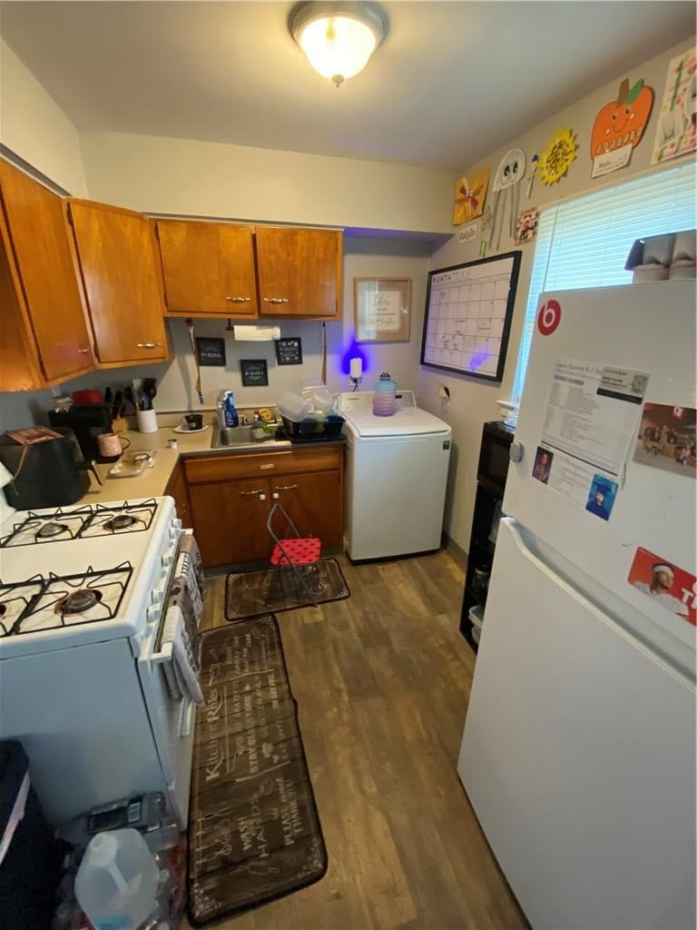 Gas range, wood kitchen cabinets and white appliances at 2603 NW Chipman Road, Lee's Summit, MO 64081