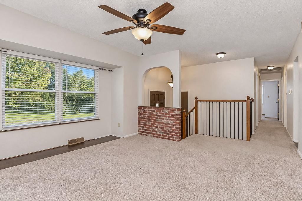 Exposed brick wall, staircase and iron stair railing at 20213 E 16th Street N, Independence, MO 64056