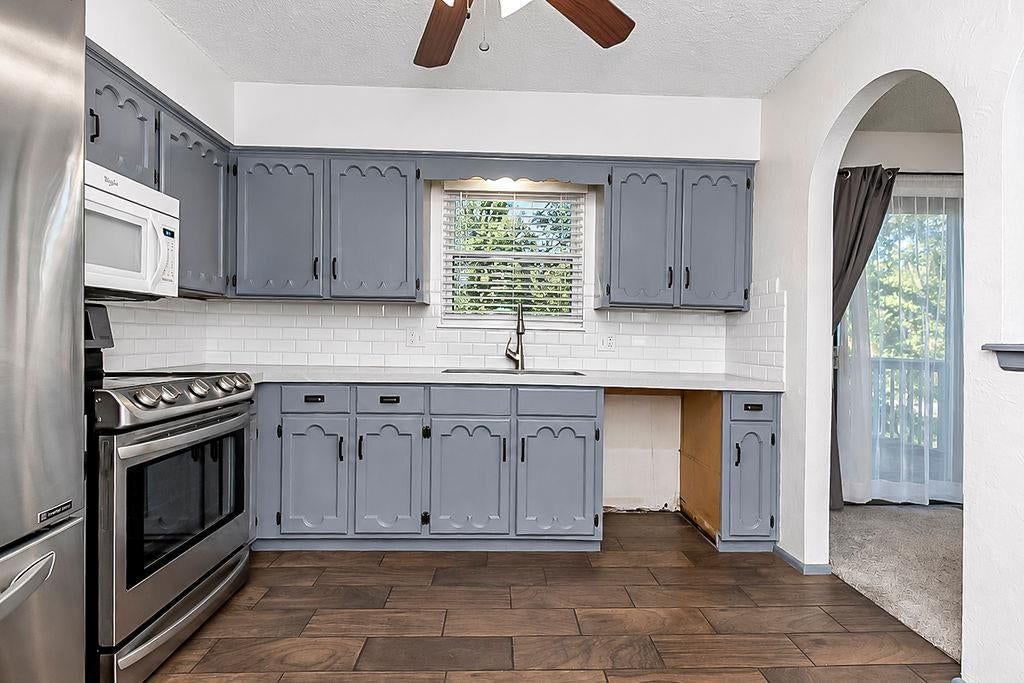 Gray kitchen cabinets, kitchen backsplash and subway tile backsplash at 20213 E 16th Street N, Independence, MO 64056