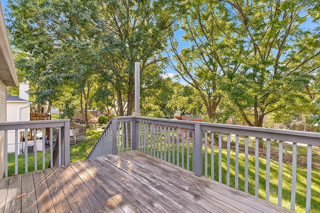 Deck, mature trees and wood deck at 20213 E 16th Street N, Independence, MO 64056