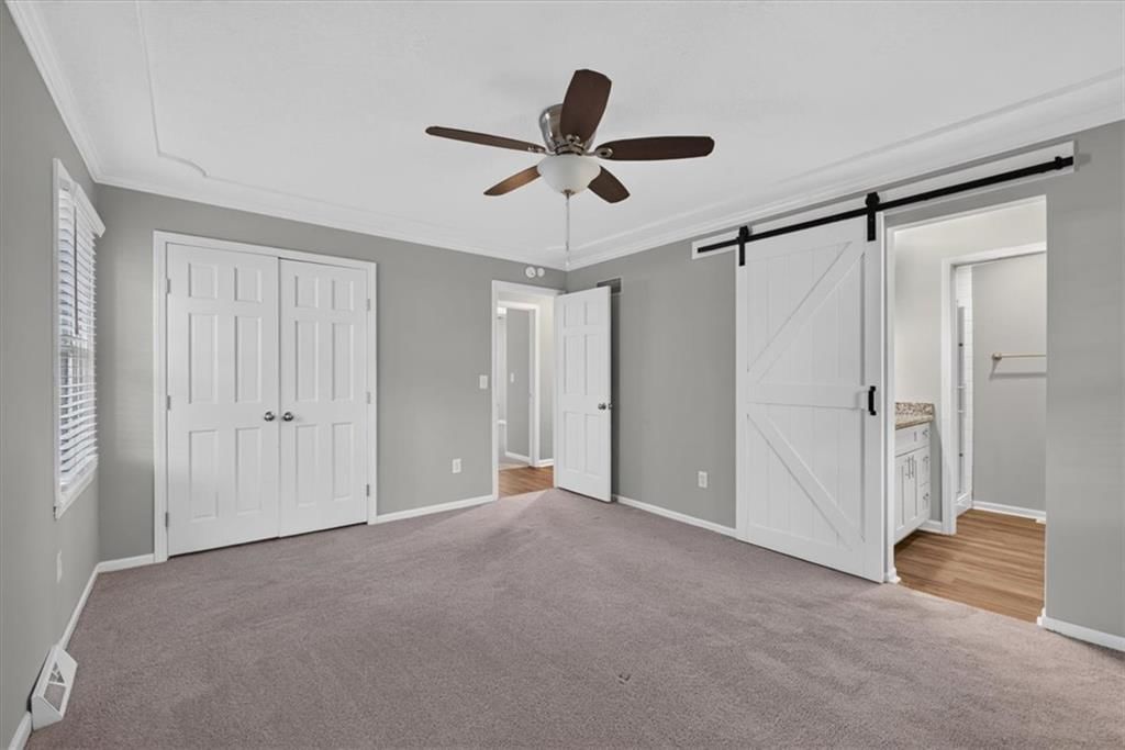 Main-floor primary bedroom at 406 SE Richardson Place, Lee's Summit, MO 64063