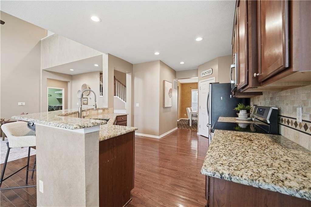 Kitchen island, granite counters and updated kitchen at 1200 SW Sapperton Road, Lee's Summit, MO 64083