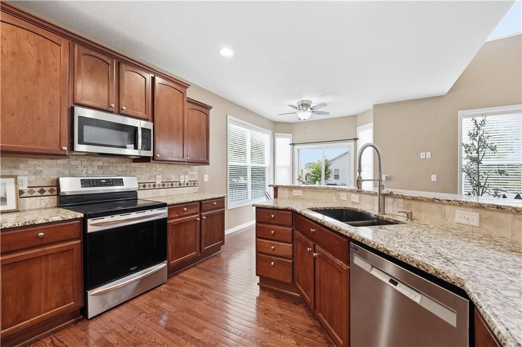 Stainless steel appliances and kitchen backsplash at 1200 SW Sapperton Road, Lee's Summit, MO 64083