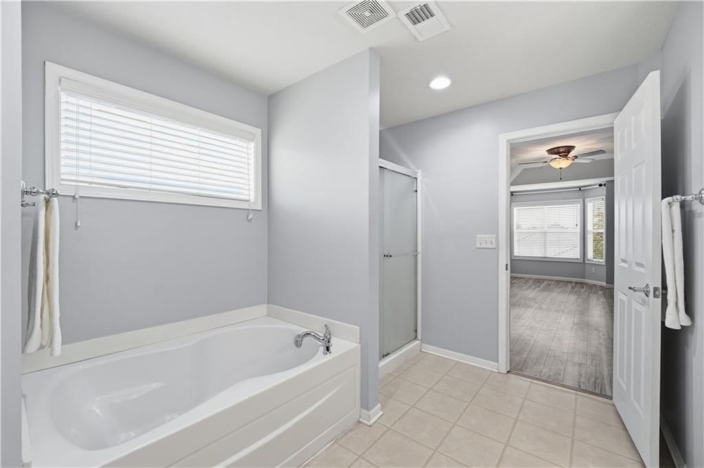 Double vanity, wood vanity and renovated bathrooms at 1200 SW Sapperton Road, Lee's Summit, MO 64083
