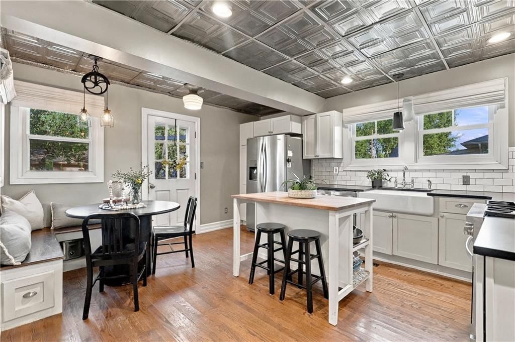Kitchen island, white kitchen and gas range at 5532 Knox Avenue, Merriam, KS 66203