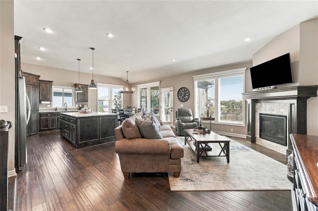 Open floor plan, kitchen island and granite counters at 12073 S Pine Street, Olathe, KS 66061