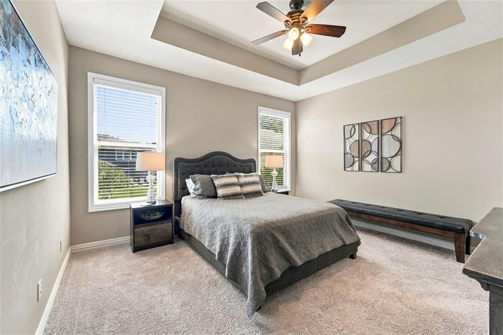 Main-floor primary bedroom and tray ceiling at 12073 S Pine Street, Olathe, KS 66061