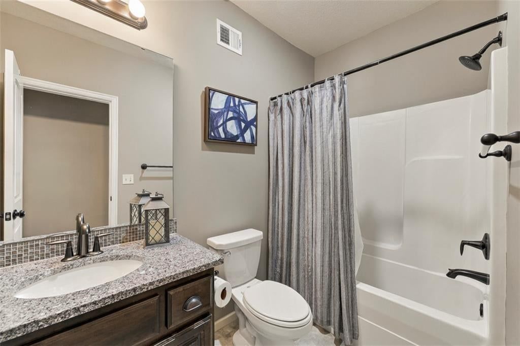 Mature trees, screened porch and covered patio at 12073 S Pine Street, Olathe, KS 66061