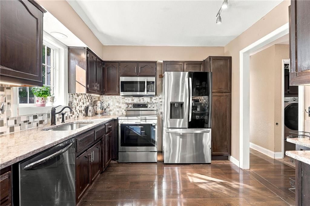 Granite counters, stainless steel appliances and black hardware at 205 NW 101st Place, Kansas City, MO 64155