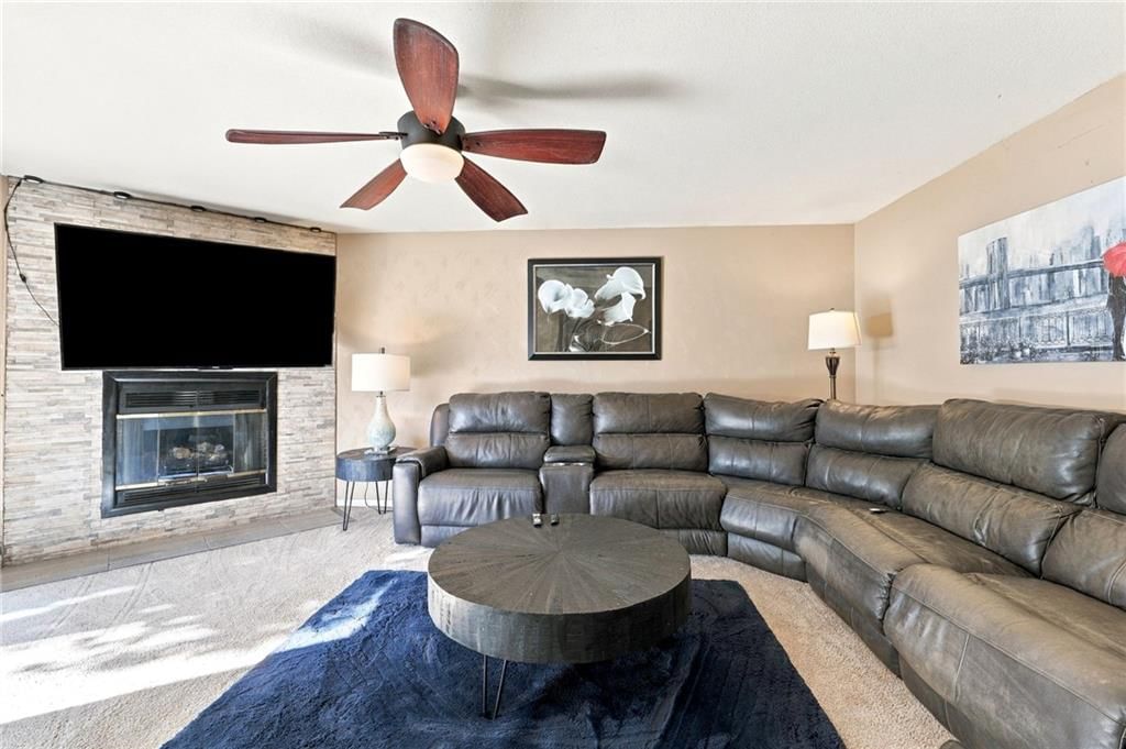 Fireplace and open floor plan at 205 NW 101st Place, Kansas City, MO 64155