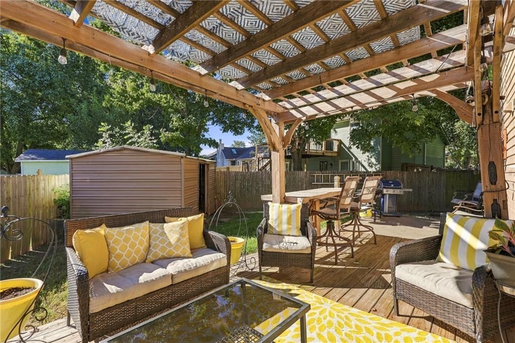 Deck, pergola and fenced yard at 205 NW 101st Place, Kansas City, MO 64155