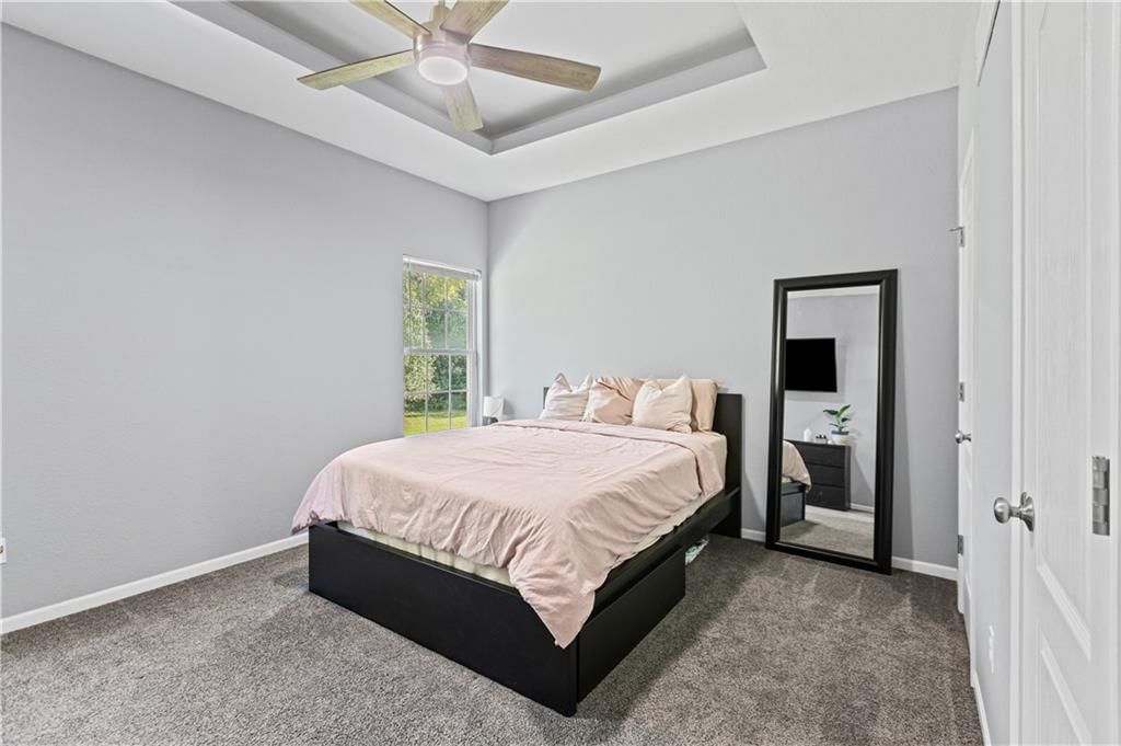 Main-floor primary bedroom and tray ceiling at 3514 NW 95th Street, Kansas City, MO 64154