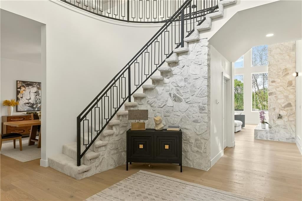 Curved staircase, statement lighting and recessed lighting at 1701 NW Duncan Road, Blue Springs, MO 64015
