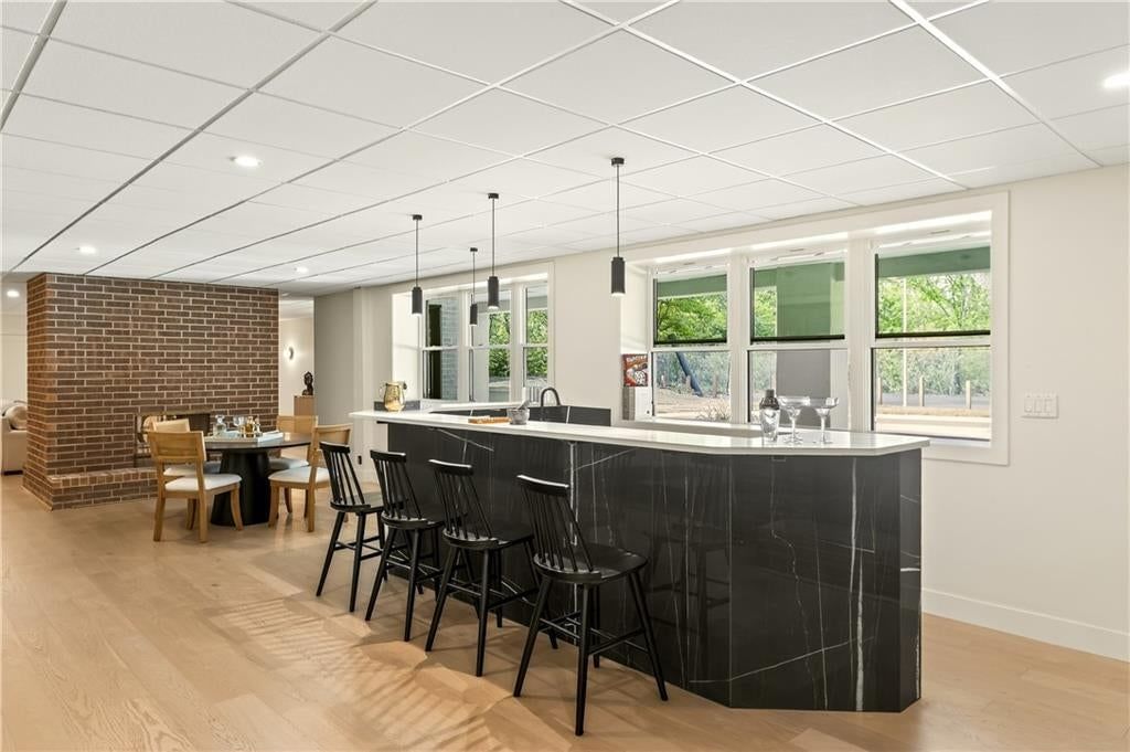 Finished basement, exposed brick wall and wet bar at 1701 NW Duncan Road, Blue Springs, MO 64015