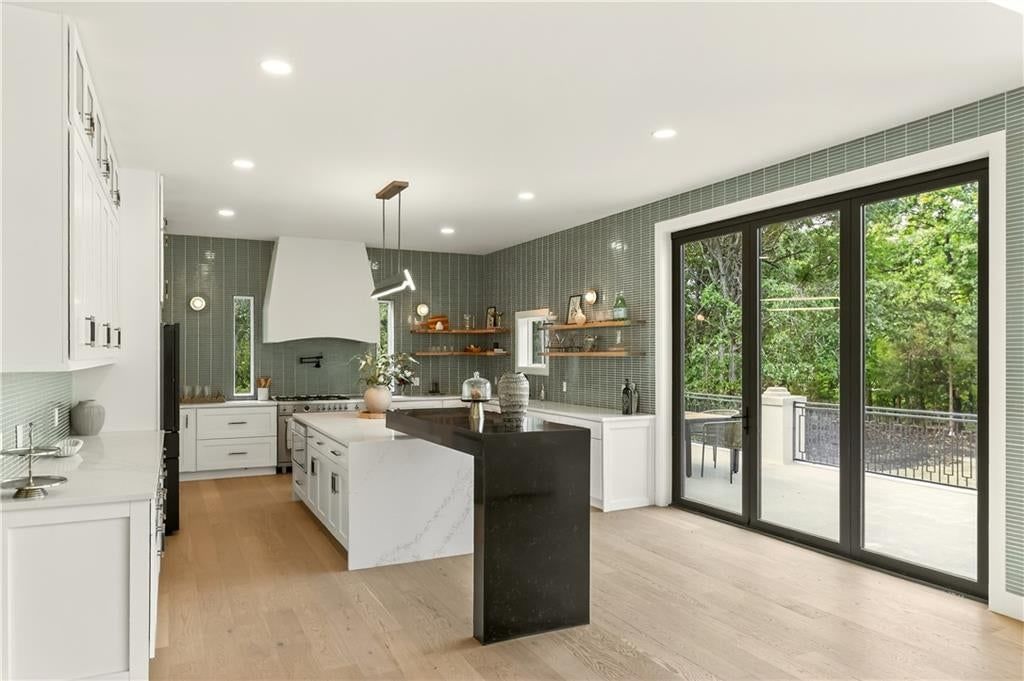 Kitchen island, white kitchen and quartz counters at 1701 NW Duncan Road, Blue Springs, MO 64015