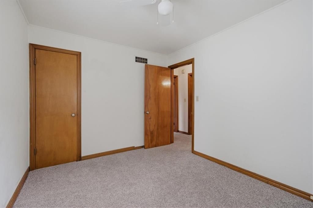 Main-floor primary bedroom at 909 E 100th Terrace, Kansas City, MO 64131