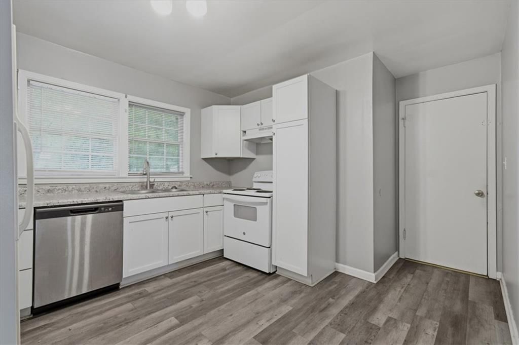 White kitchen, shaker cabinets and mixed-finish appliances at 10002 Belmont Avenue, Kansas City, MO 64134