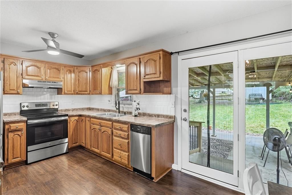 Stainless steel appliances, wood kitchen cabinets and electric range at 16317 E 34th Street S, Independence, MO 64055