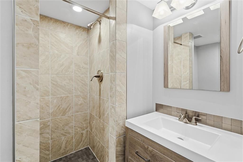 Walk-in shower and tiled shower at 16317 E 34th Street S, Independence, MO 64055
