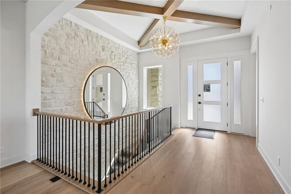 Statement lighting, ceiling beams and staircase at 13725 Pembroke Lane, Leawood, KS 66224