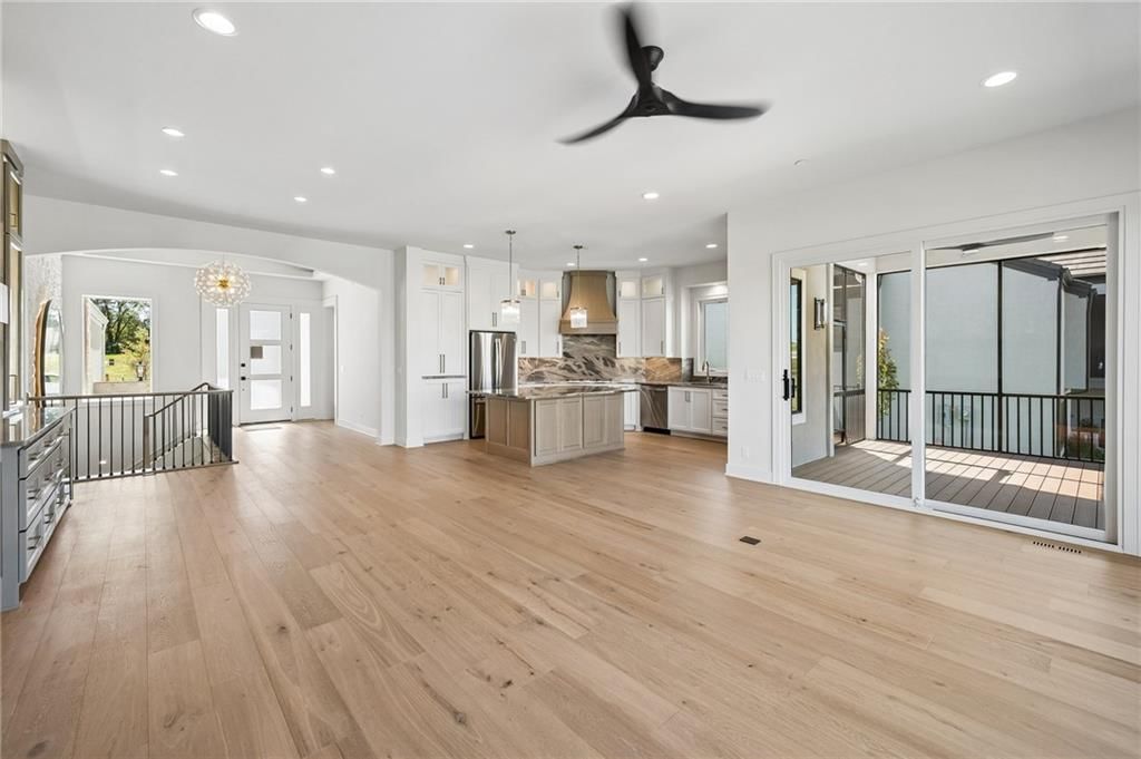 Tall ceilings, open floor plan and hardwood floors at 13725 Pembroke Lane, Leawood, KS 66224