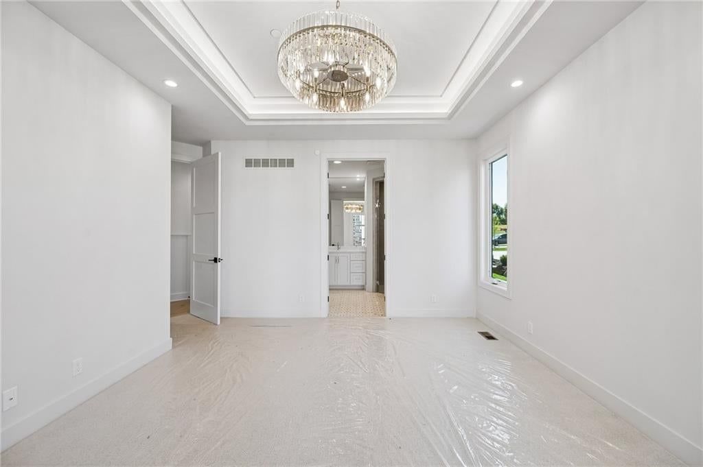 Tray ceiling, black hardware and carpet at 13725 Pembroke Lane, Leawood, KS 66224