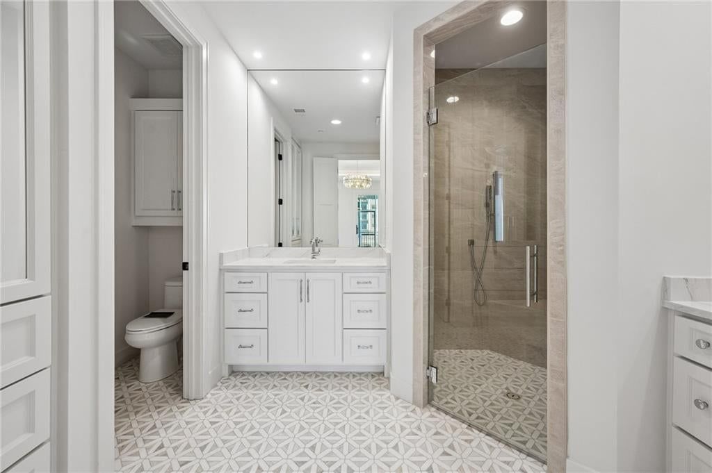 Walk-in shower, private toilet room and tiled shower at 13725 Pembroke Lane, Leawood, KS 66224