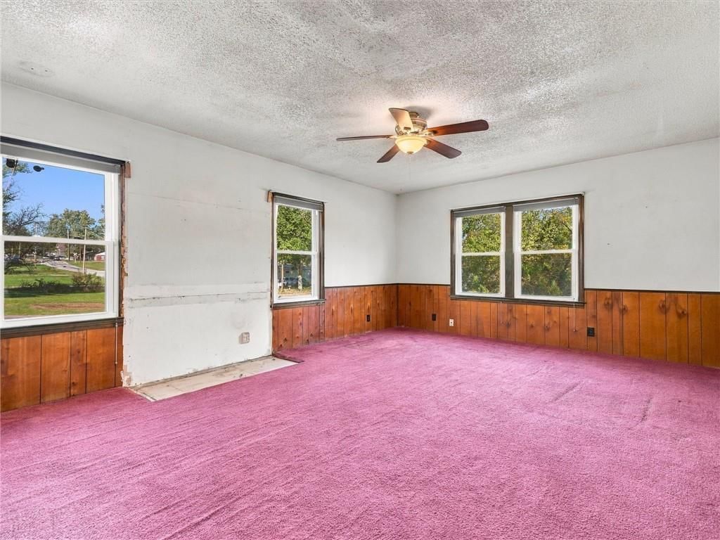 Main-floor primary bedroom and carpet at 500 S Hunter Street, Independence, MO 64050