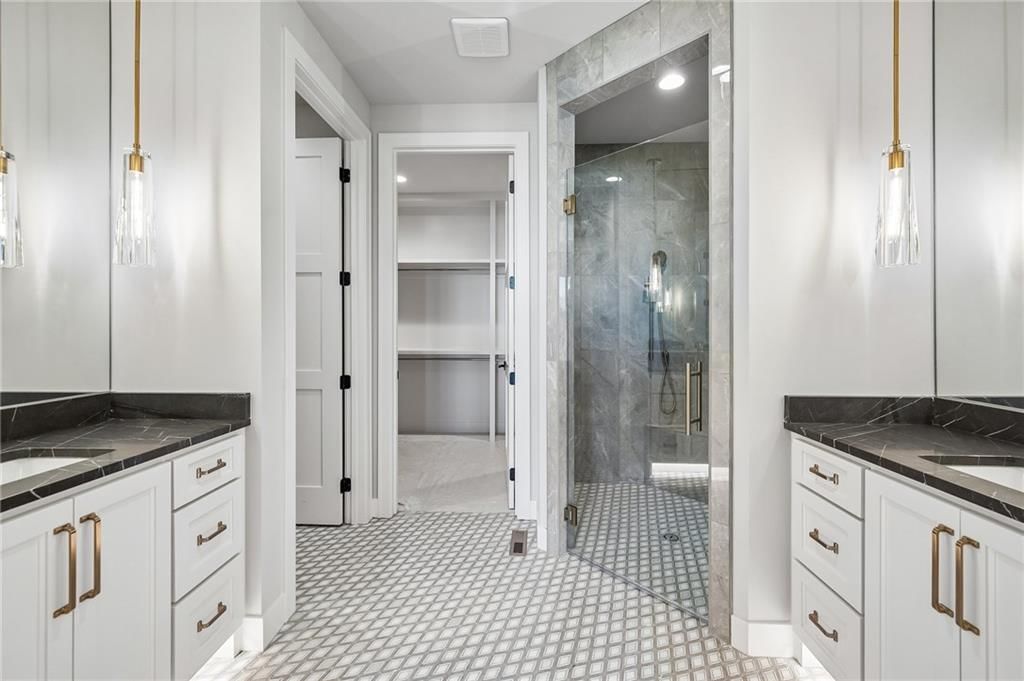 Walk-in shower, tiled shower and double vanity at 13727 Pembroke Lane, Leawood, KS 66224