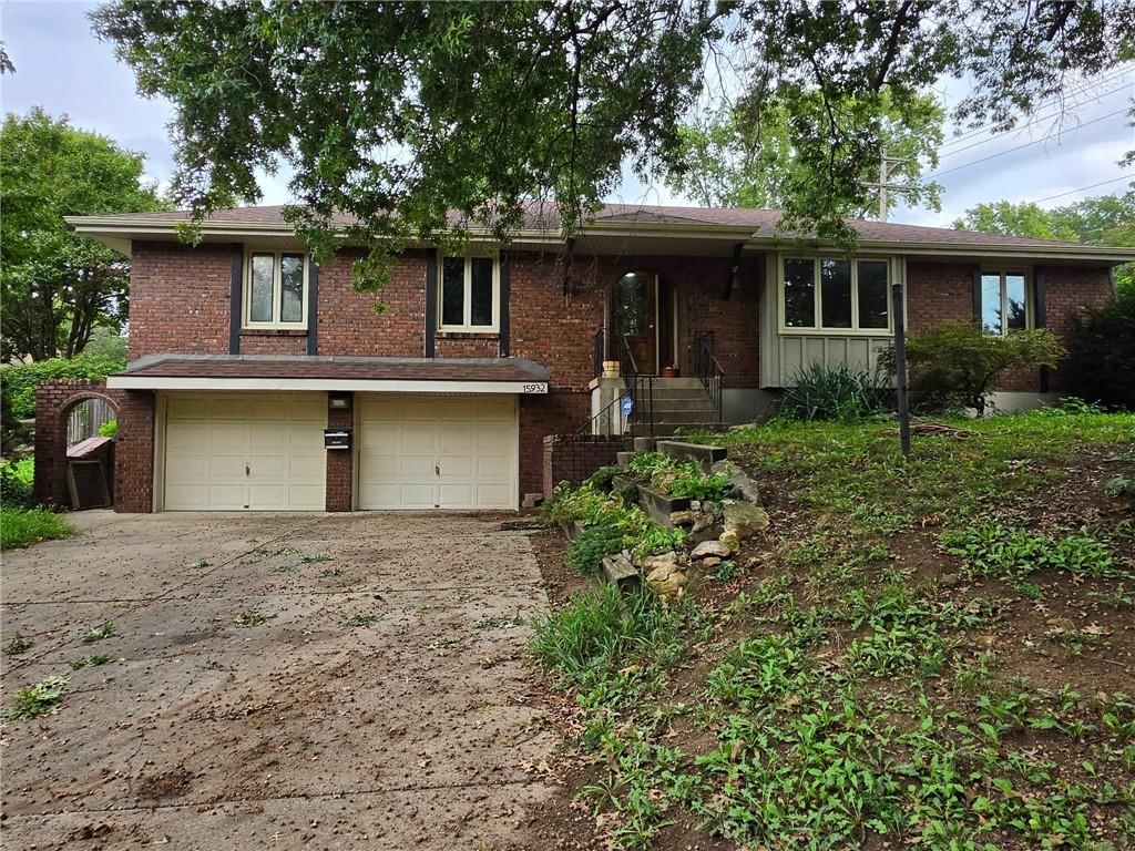 Brick exterior, fenced yard and mature trees at 15932 E 41st Street S, Independence, MO 64055