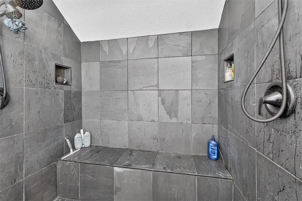 Walk-in shower, tiled shower and double vanity at 713 NW Eagle Ridge Circle, Lee's Summit, MO 64081