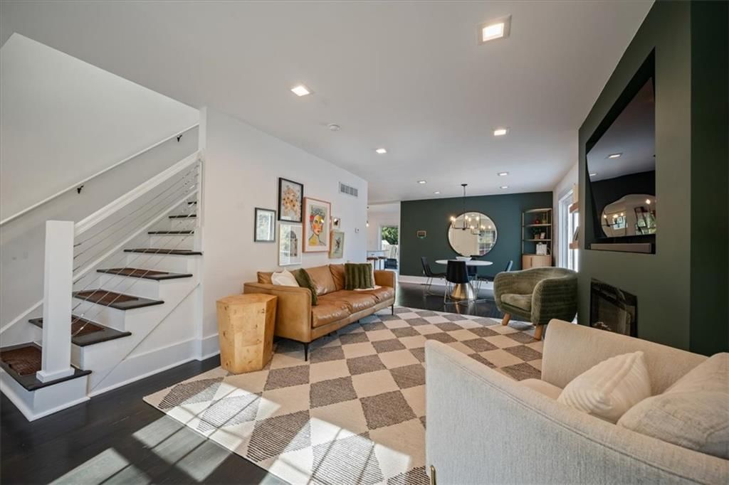 Fireplace, open floor plan and accent wall at 8639 Maiden Lane, Kansas City, MO 64114