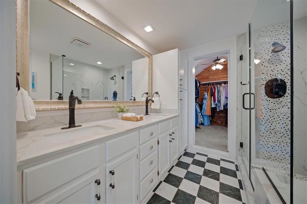 Walk-in shower, tiled shower and double vanity at 8639 Maiden Lane, Kansas City, MO 64114