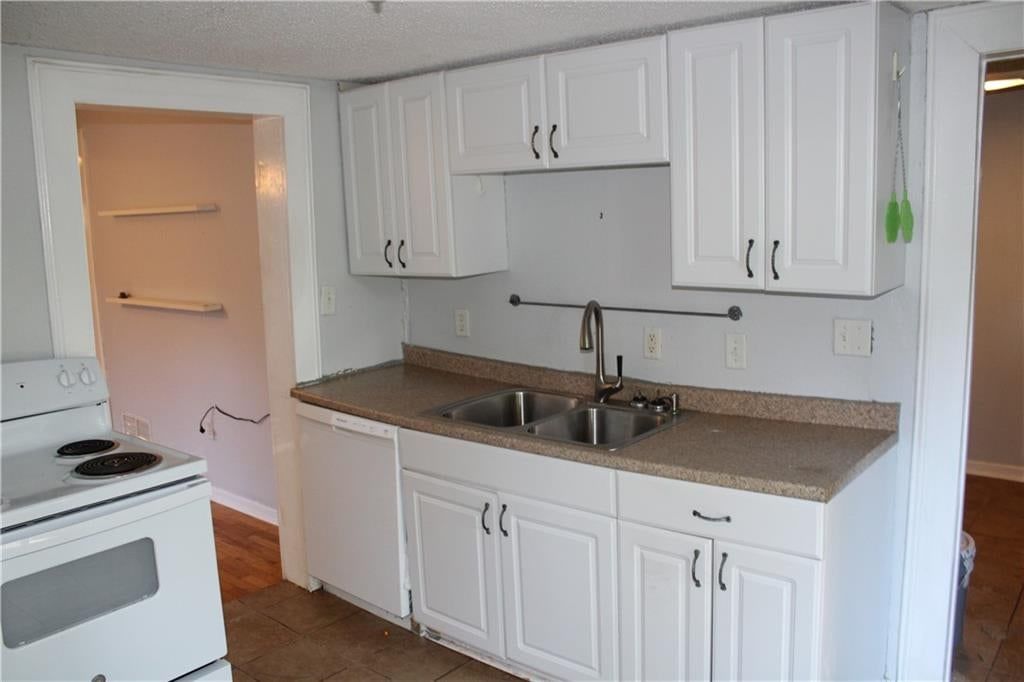 Photo 9: white kitchen cabinets, 7811 Summit Street, Kansas City, MO 64114