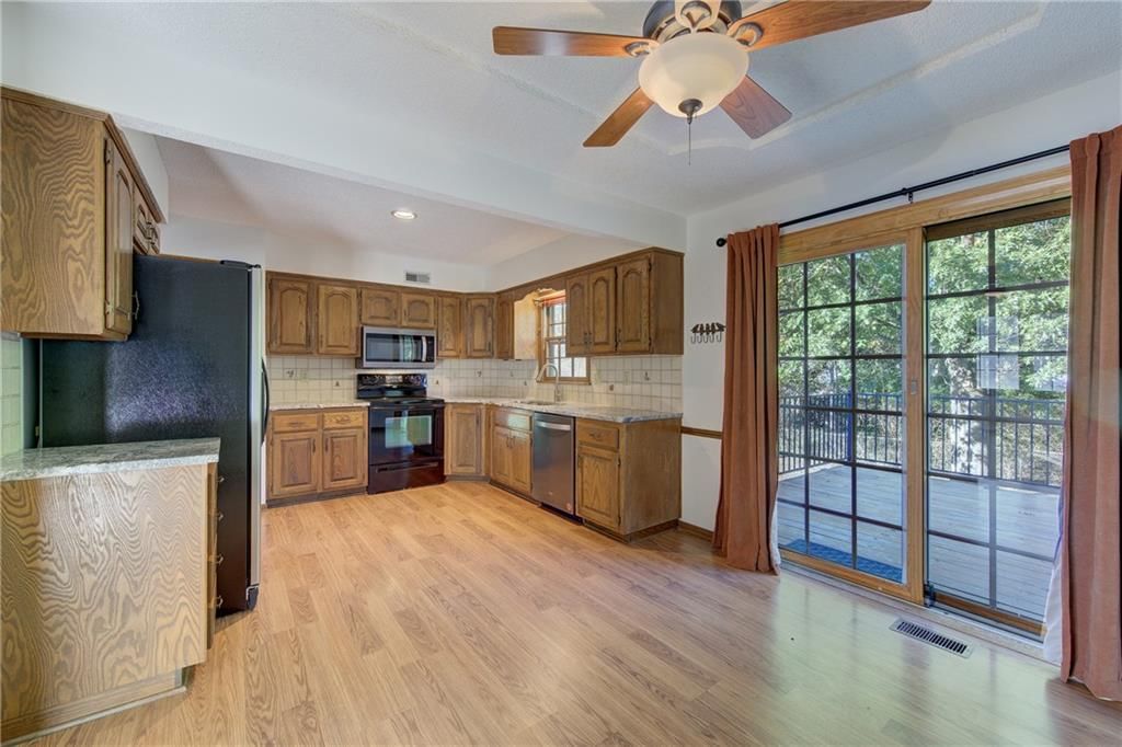 Open floor plan, hardwood floors and breakfast nook at 5712 Long Avenue, Shawnee, KS 66216