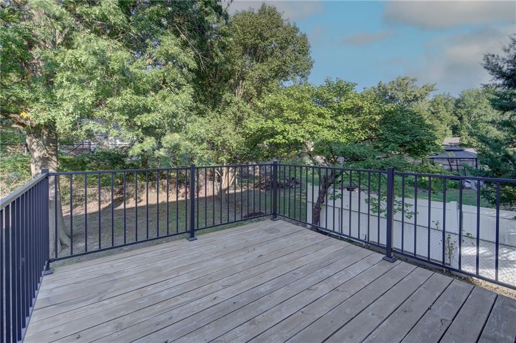 Deck, fenced yard and mature trees at 5712 Long Avenue, Shawnee, KS 66216