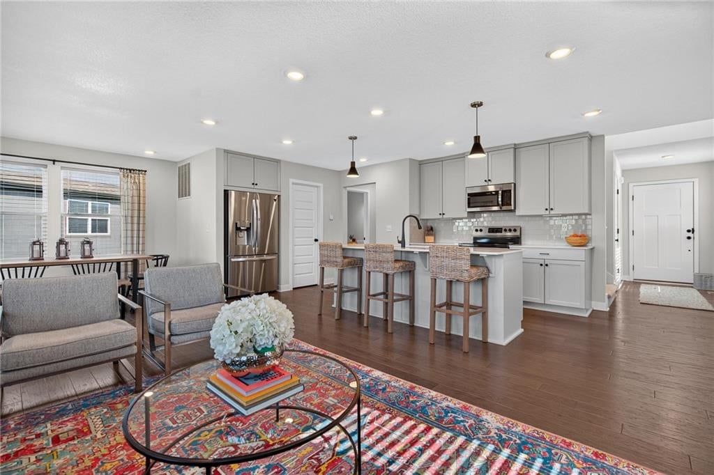 Open floor plan, kitchen island and quartz counters at 18068 Hauser Street, Overland Park, KS 66013