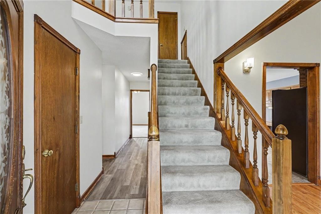 Staircase, wood stair railing and carpet at 26503 283rd Street, Harrisonville, MO 64701