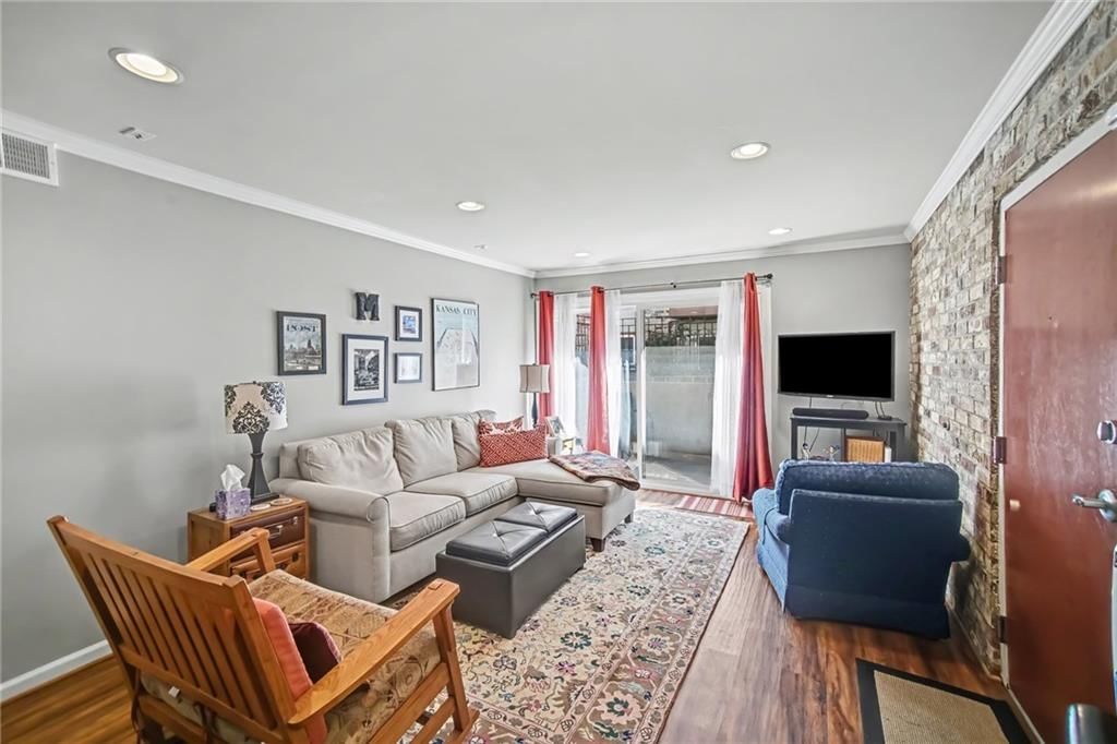 Exposed brick wall, recessed lighting and white trim at 5004 Baltimore Avenue #103, Kansas City, MO 64112