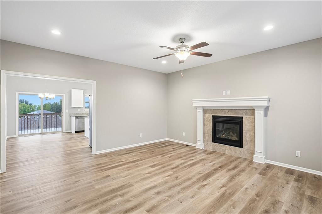Open floor plan, luxury vinyl floors and recessed lighting at 1208 NW Hilltop Lane, Grain Valley, MO 64029