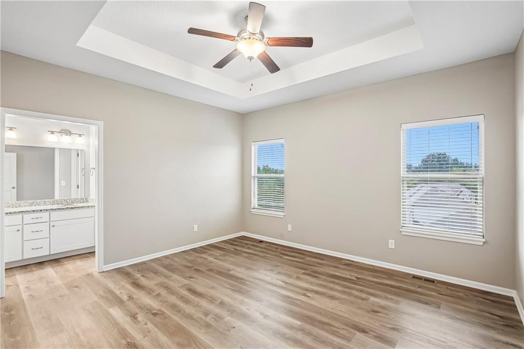 Main-floor primary bedroom at 1208 NW Hilltop Lane, Grain Valley, MO 64029