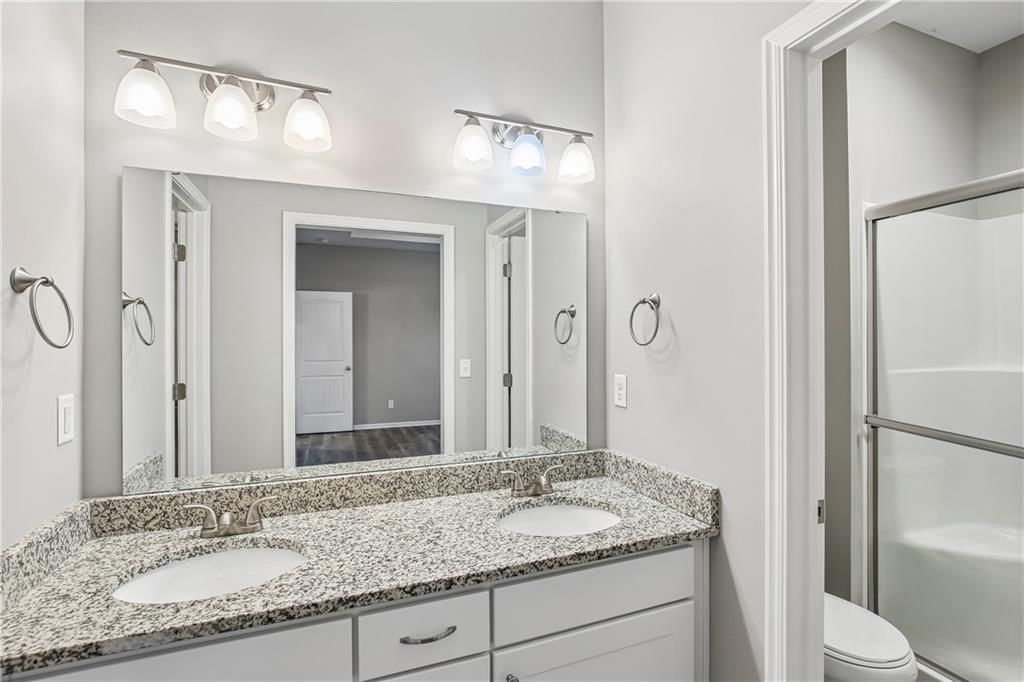 Double vanity and white vanity at 1208 NW Hilltop Lane, Grain Valley, MO 64029