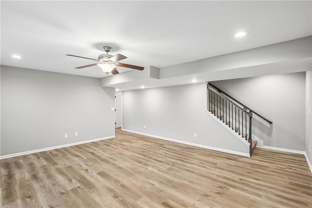 Finished basement, staircase and iron stair railing at 1208 NW Hilltop Lane, Grain Valley, MO 64029