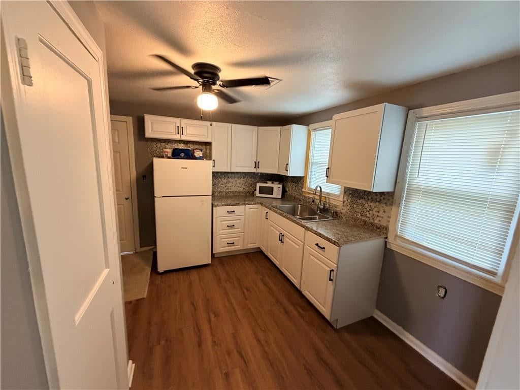 White kitchen, white appliances and kitchen backsplash at 3004 E Meyer Boulevard, Kansas City, MO 66418