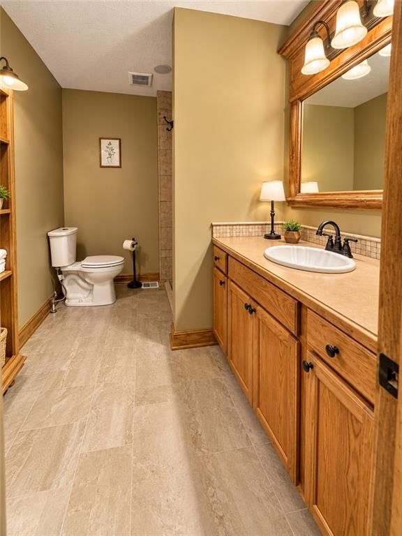 Main-floor primary bedroom and black hardware at 112 W 8th Street, Kearney, MO 64060