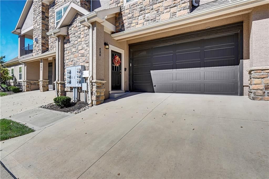 Attached garage and concrete driveway at 16001 Granada Street #230, Stilwell, KS 66085