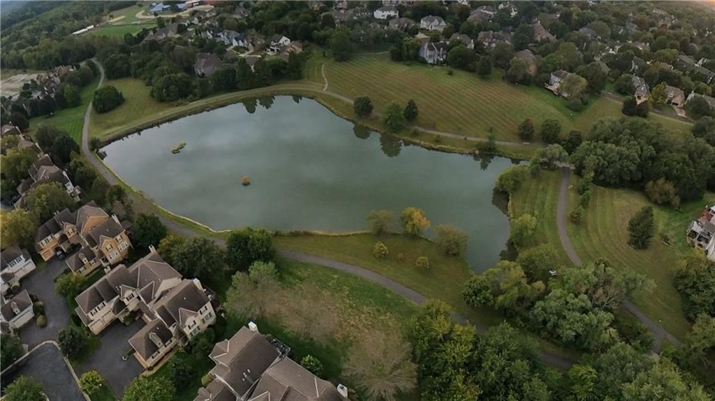 Pond or creek visible on the lot at 16001 Granada Street #230, Stilwell, KS 66085