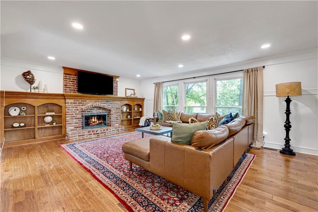 Fireplace, exposed brick wall and wall of windows at 12432 Perry Street, Overland Park, KS 66213